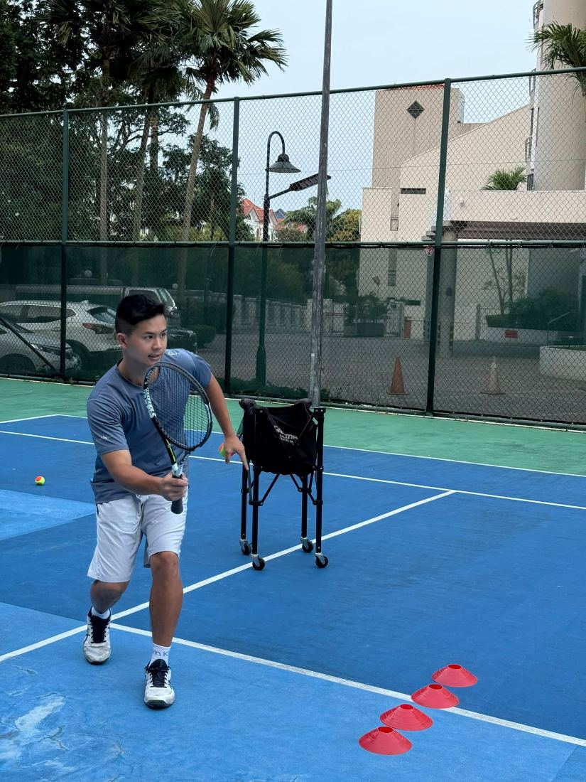 Sherwin Foo in the ready position preparing a backhand