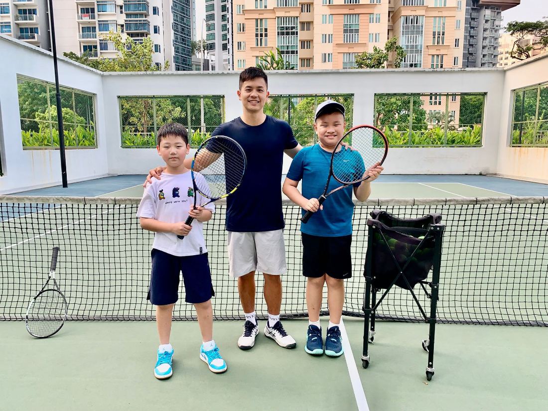 Coach Sherwin Foo with two junior players at the net