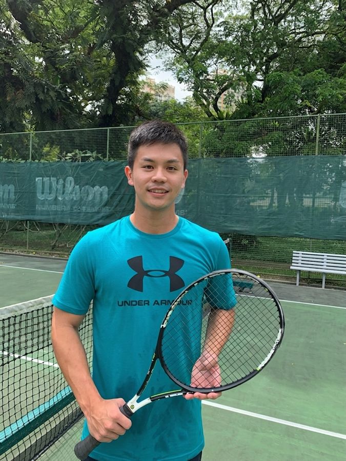 Coach Sherwin Foo courtside with his racquet